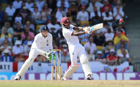 Cricket - West Indies v England - Third Test - Kensington Oval, Barbados - 2/5/15 West Indies' Jermaine Blackwood hits a six as England's Jos Buttler looks on Action Images via Reuters / Jason O'Brien