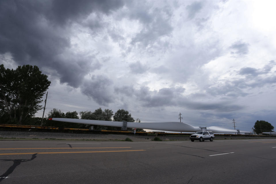 FILE - In this June 30, 2016, file photo, a train carries blades for wind turbines bound for another state through Rocky Ford, Colo., in Otero County. Both Rocky Ford, Colo., and Dawson, Ga., were classified as urban areas after the 2010 census because they had populations over 2,500 residents. Under new criteria posted this spring by the U.S. Census Bureau, these communities would no longer be designated as urban. The new criteria require places to have 2,000 housing units, which is equivalent to 5,000 residents, to be considered an urban area. (AP Photo/Brennan Linsley, File)