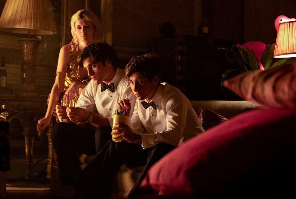 Venetia (Alison Oliver, left), Felix (Jacob Elordi) and Oliver (Barry Keoghan) unravel over a summer spent at the opulent Saltburn mansion.