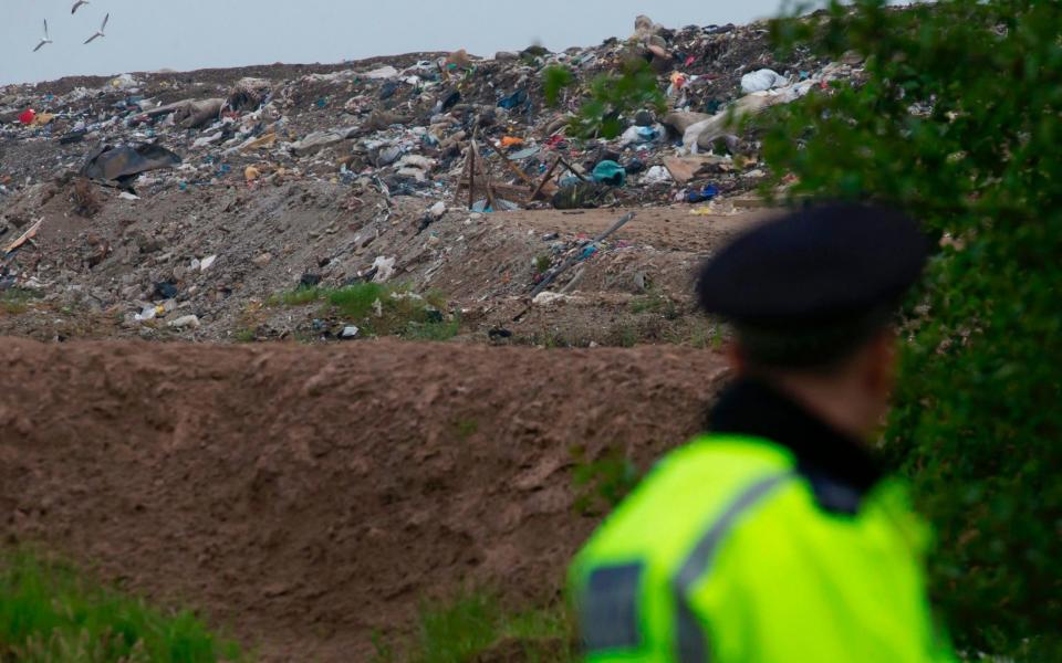 A police officer stands on duty outside of the Viridor Waste Management plant in Pilsworth, near Bury, north of Manchester, northwest England on May 29, 2017, as police continue their investigations in the wake of the May 22 Manchester Arena bomb attack - Credit: Jon Super /AFP