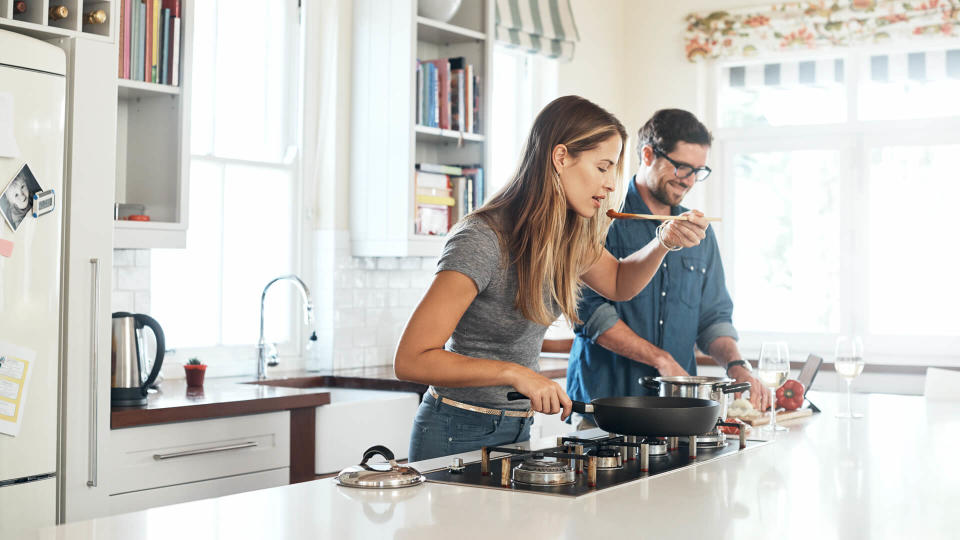 Shot of a young couple cooking a meal together at home.