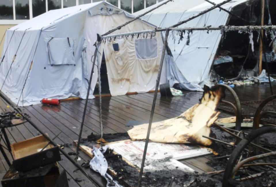 In this photo provided by Russian Emergency Situations Ministry for the Khabarovsk Region Press Service, a tent camp is seen after a fire near Solnechny village, Khabarovsk Region, Russia, Thursday, July 23, 2019. Russian authorities say three children have died in a fire at the tent camp in a ski area in the Khabarovsk region about 6,000 kilometers (3,700 miles) east of Moscow, that housed some 189 people at the time of the fire, news reports said. (Ministry of Emergency Situations for Khabarovsk Region Press Service via AP)