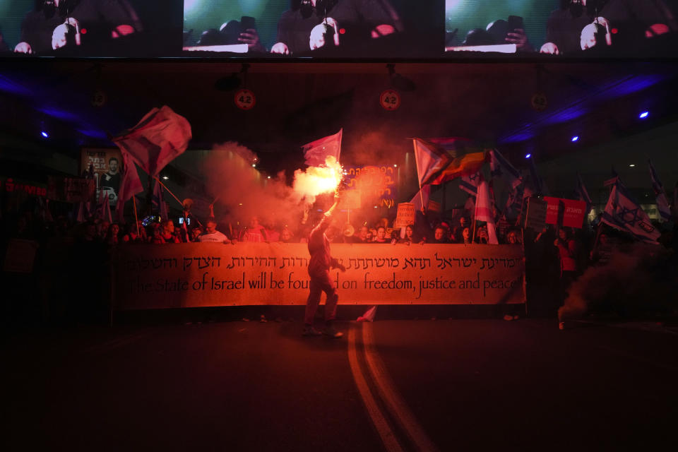 Israelis protest against plans by Prime Minister Benjamin Netanyahu's new government to overhaul the judicial system, in Tel Aviv, Israel, Saturday, Feb. 18, 2023. (AP Photo/Tsafrir Abayov)