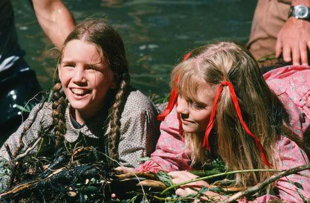 <p>NBCU Photo Bank/Getty</p> Melissa Gilbert as Laura Elizabeth Ingalls Wilder and Alison Arngrim as Nellie Oleson