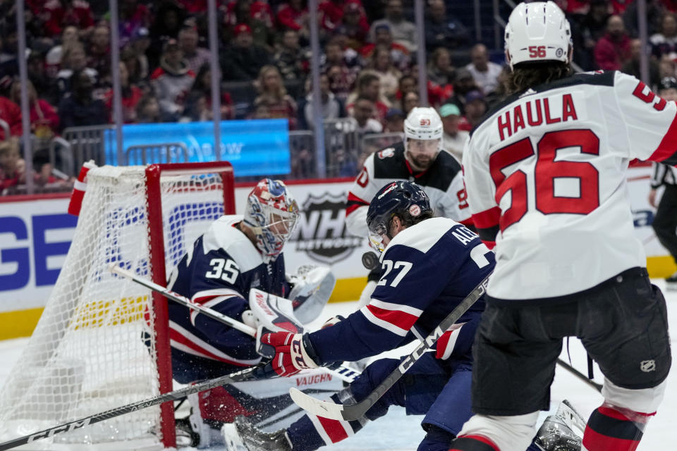 A goal by New Jersey Devils left wing Erik Haula (56) rolls past Washington Capitals defenseman Alexander Alexeyev (27) and gets past Washington Capitals goaltender Darcy Kuemper (35) in the second period of an NHL hockey game, Thursday, March 9, 2023, in Washington. (AP Photo/Alex Brandon)