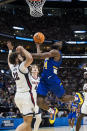 McNeese State guard Javohn Garcia (14) shoots the ball on Gonzaga forward Anton Watson (22) during the first half of a first-round college basketball game in the NCAA Tournament in Salt Lake City, Thursday, March 21, 2024. (AP Photo/Isaac Hale)