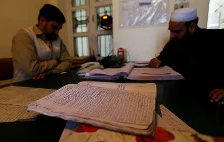 The original police complaint in the case of the killing of Ambreen Riasat is seen on the desk of police as they work in the Donga Gali police station outside Abbottabad, Pakistan May 6, 2016. REUTERS/Caren Firouz TPX IMAGES OF THE DAY