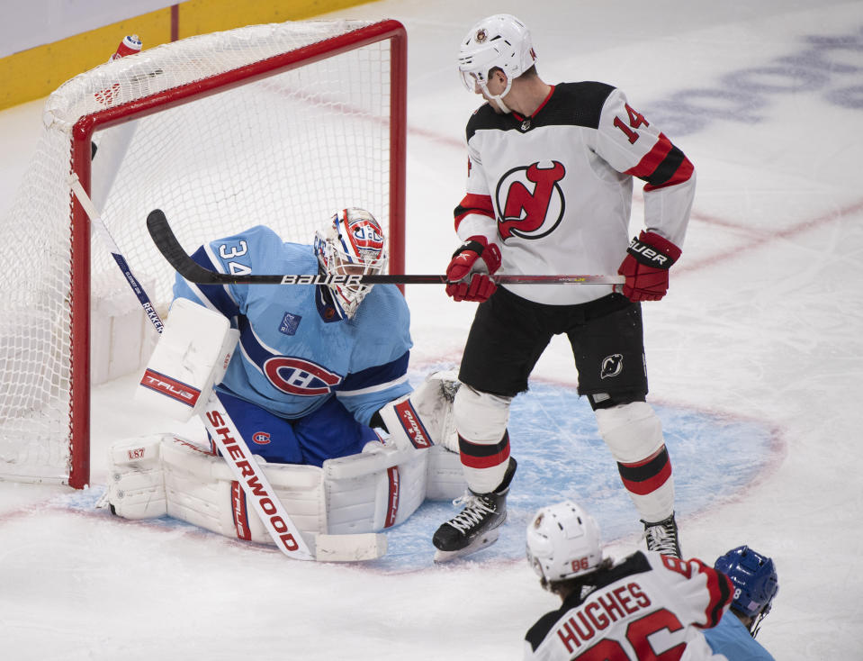 Montreal Canadiens goaltender Jake Allen is scored on by New Jersey Devils' Jack Hughes (86) as Devils' Nathan Bastian looks for a rebound during the second period of an NHL hockey game, Tuesday, Nov. 15, 2022 in Montreal. (Graham Hughes/The Canadian Press via AP)