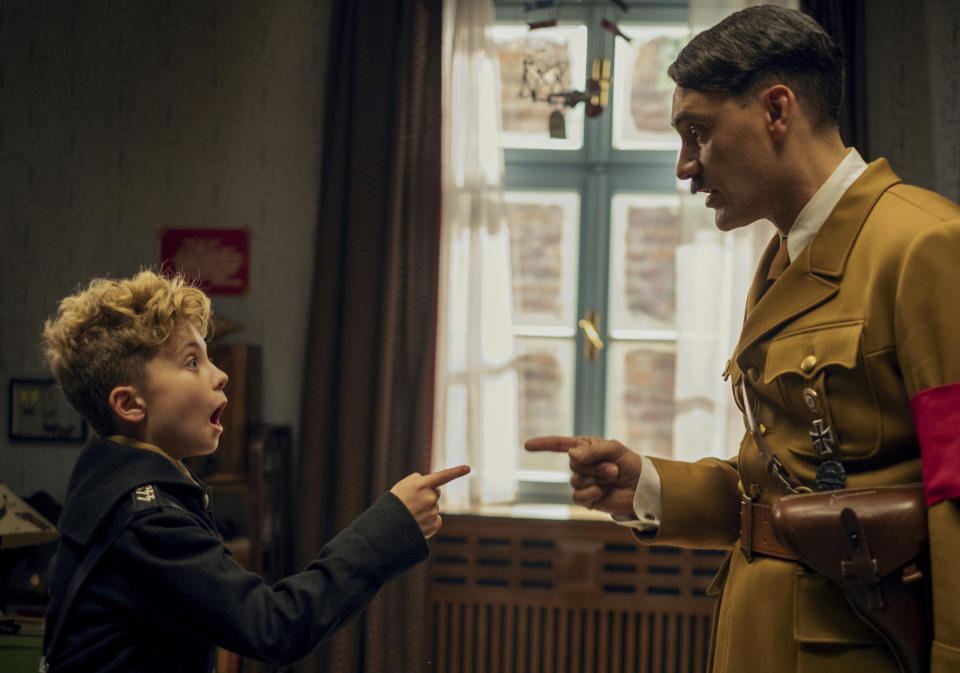 This image released by Fox Searchlight Pictures shows, from left, Roman Griffin Davis and Taika Waititi in a scene from the WWII satirical film "Jojo Rabbit." (Kimberley French/Fox Searchlight Pictures via AP)