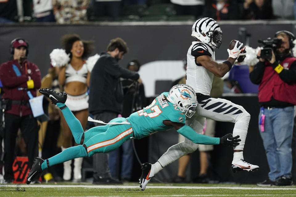 Cincinnati Bengals' Ja'Marr Chase makes a catch against Miami Dolphins' Keion Crossen (27) during the second half of an NFL football game, Thursday, Sept. 29, 2022, in Cincinnati. (AP Photo/Joshua A. Bickel)