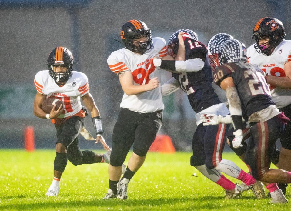 Harlem's Jahmani Muhammad finds an opening and picks up a few yards against Belvidere North on Friday, Oct. 13, 2023, at Belvidere North High School in Belvidere.