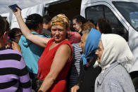 People receive humanitarian aid in the village of Andriivka, Donetsk region, Ukraine, Saturday, May 28, 2022. (AP Photo/Andriy Andriyenko)