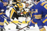 Pittsburgh Penguins forward Sidney Crosby (87) passes the puck during the second period of an NHL hockey game against the Buffalo Sabres, Sunday, April 18, 2021, in Buffalo, N.Y. (AP Photo/Jeffrey T. Barnes)