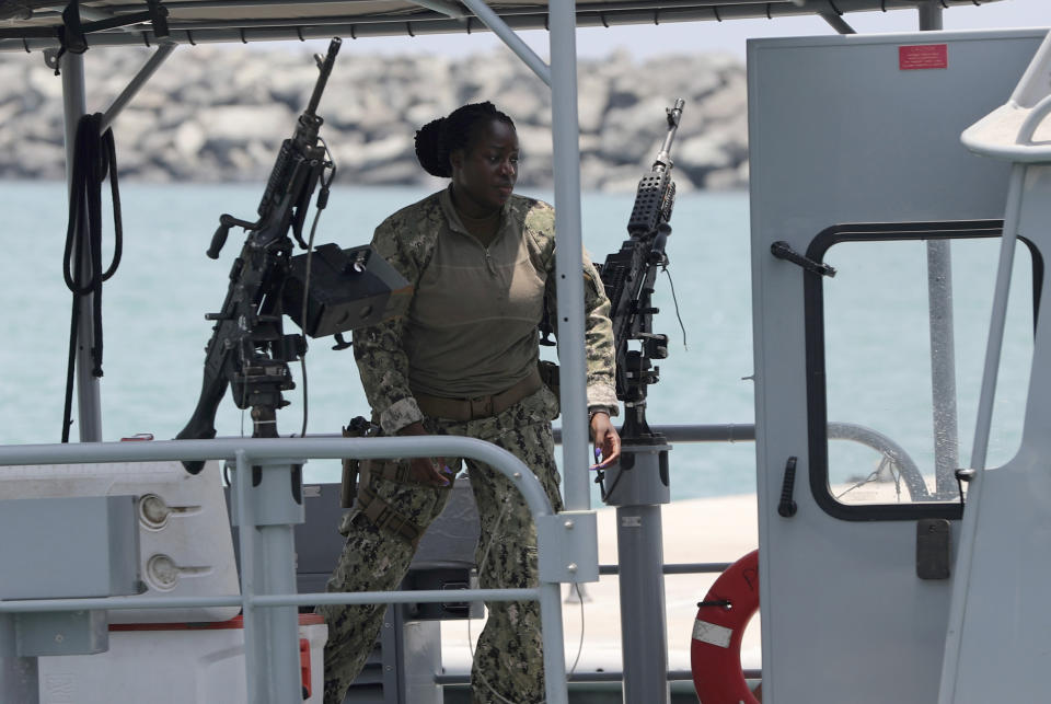 A U.S. Navy personnel prepares at a patrol boat to carry journalists to see damaged oil tankers leaves a U.S. Navy 5th Fleet base, during a trip organized by the Navy for journalists, near Fujairah, United Arab Emirates, Wednesday, June 19, 2019. Cmdr. Sean Kido of the U.S. Navy's 5th Fleet said Wednesday that the limpet mine used on a Japanese-owned oil tanker last week "bears a striking resemblance" to similar Iranian mines. Iran has denied being involved. (AP Photo/Kamran Jebreili)