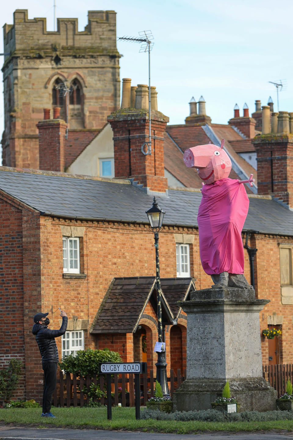 A village is hunting festive pranksters who have turned a statue of its most famous son into PEPPA PIG. The statue of Lord John Scott, who died in 1860, is a Christmas target for jokers in Dunchurch, near Rugby, Warks. Hilarious pictures show the monument draped in a pink sheet with arms stretched out and a huge pink papier mache head resembling kids' TV favourite. The statue has previously been turned into Harry Potter, Shrek, Happy Feet, Pikachu, Homer Simpson, an Olympic athlete and The Grinch in an annual tradition dating back to the 1970s.