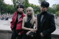 V, from left, Lisa, and Park Bo-gum pose for photographers before the Celine men's Spring Summer 2023 collection presented in Paris, France, Sunday, June 26, 2022. (AP Photo/Francois Mori)