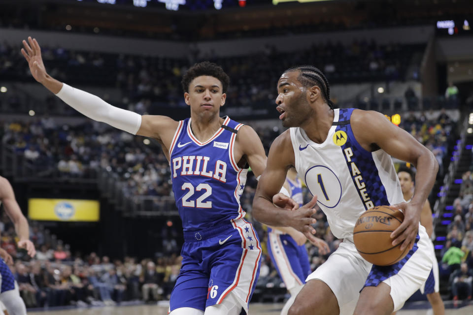 Indiana Pacers' T.J. Warren (1) is defended by Philadelphia 76ers' Matisse Thybulle (22) during the first half of an NBA basketball game, Monday, Jan. 13, 2020, in Indianapolis. (AP Photo/Darron Cummings)