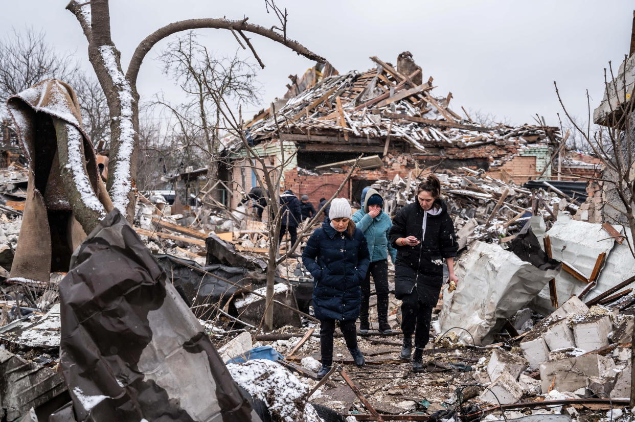 Women walk among remains of residential buildings destroyed by shelling, as Russia's invasion of Ukraine continues, in Zhytomyr, Ukraine. (Reuters)