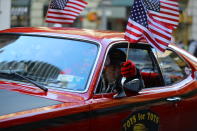 <p>A veteran drives an old Plymouth while waving a flag up Fifth Avenue during the Veterans Day parade in New York City on Nov. 11, 2017. (Photo: Gordon Donovan/Yahoo News) </p>