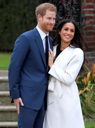FILE PHOTO: Britain's Prince Harry poses with Meghan Markle in the Sunken Garden of Kensington Palace, London, Britain, November 27, 2017. REUTERS/Toby Melville/File Photo