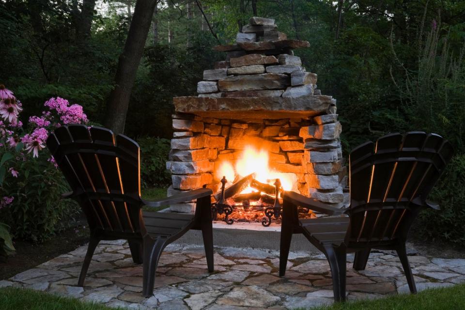 <p>There's just something so cozy about a fire this time of year—the crackle, the smell, and the fun of roasting hot dogs and toasting marshmallows for the <a href="https://www.countryliving.com/food-drinks/a28189946/smores-recipe/" rel="nofollow noopener" target="_blank" data-ylk="slk:best s'mores recipes;elm:context_link;itc:0;sec:content-canvas" class="link ">best s'mores recipes</a>. Even though campfires get most of the glory, homeowners are embracing the romantic appeal of enjoying a fire in their very own backyards. From stone outdoor fireplace ideas to a DIY concrete fire bowl with river rocks and stylish store-bought metal fire pits, these ideas cover every skill set and budget. </p><p>Whether you have a large, sprawling back lawn or are looking for <a href="https://www.countryliving.com/gardening/news/g4183/small-backyard-ideas/" rel="nofollow noopener" target="_blank" data-ylk="slk:small backyard ideas;elm:context_link;itc:0;sec:content-canvas" class="link ">small backyard ideas</a>, an outdoor fireplace or fire pit is something to consider. Custom built-in designs can be on the pricier side, but for smaller budgets, there are plenty of super affordable options for fire pits and chimineas (a great pick for small spaces!) that are just a click away on Amazon. If you're in the mood for a <a href="https://www.countryliving.com/diy-crafts/" rel="nofollow noopener" target="_blank" data-ylk="slk:project;elm:context_link;itc:0;sec:content-canvas" class="link ">project</a>, try your hand at one of these DIY outdoor fireplace ideas.</p><p>Either way, you can be relaxing by the glow of a warm fire in no time, whether you buy a fire pit for your patio or build an outdoor fireplace from scratch. Now, who's bringing the hot dogs and marshmallows?</p><p><em>Are you looking for more inspiration for your backyard during harvest season? Consider adding a beautiful and durable rug to your personal fireside retreat! Take a look at the <a href="https://www.countryliving.com/shopping/g40155695/best-outdoor-patio-rugs/" rel="nofollow noopener" target="_blank" data-ylk="slk:10 best outdoor rugs;elm:context_link;itc:0;sec:content-canvas" class="link ">10 best outdoor rugs </a>to upgrade your patio style through rain, sunshine, or the cold season ahead. And don't forget to add some <a href="https://www.countryliving.com/gardening/garden-ideas/g4662/fall-flowers/" rel="nofollow noopener" target="_blank" data-ylk="slk:pretty fall flowers;elm:context_link;itc:0;sec:content-canvas" class="link ">pretty fall flowers </a>to your garden too!</em></p>