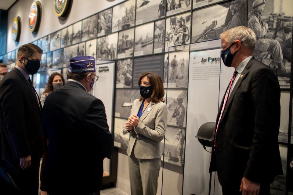 Richard Drago, commander of the Military Order of the Purple Heart, left, presents Lt. Gov. Kathy Hochul with a challenge coin at the dedication of the newly expanded National Purple Heart Hall of Honor in New Windsor, N.Y., on Nov. 11, 2020.