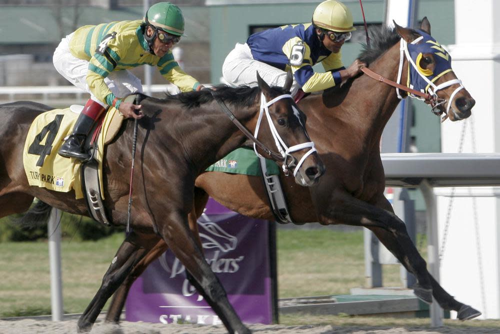 Jockey Patrick Husbands aboard Sealy Hill, right, wins by a neck against Panty Raid ridden by Edgar Prado, in the Bourbonette Breeders’ Cup horse race at Turfway Park in Florence, Ky., in this Saturday, March 24, 2007, file photo. (AP Photo/David Kohl, File)