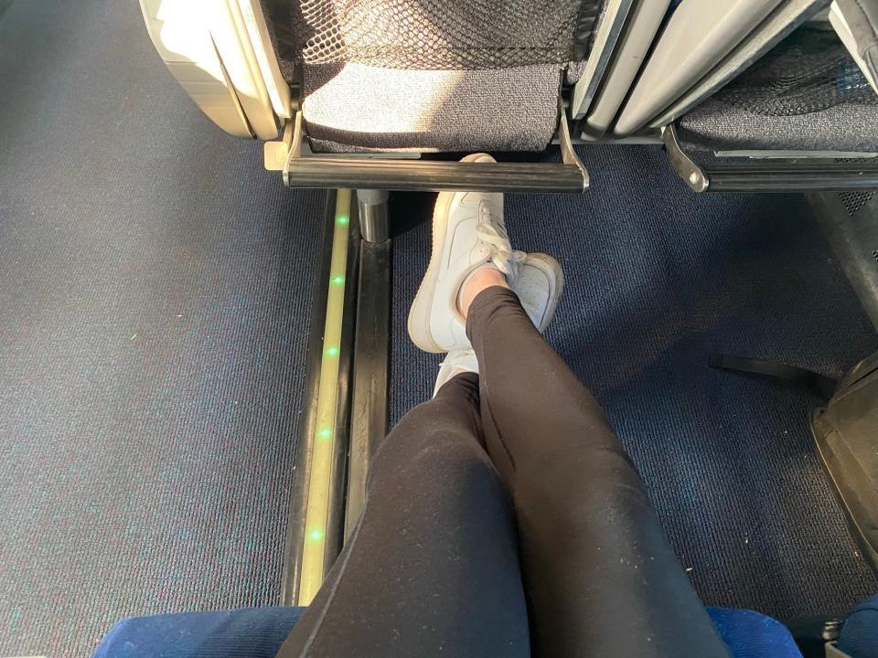 person stretchign their legs in an amtrak train seat
