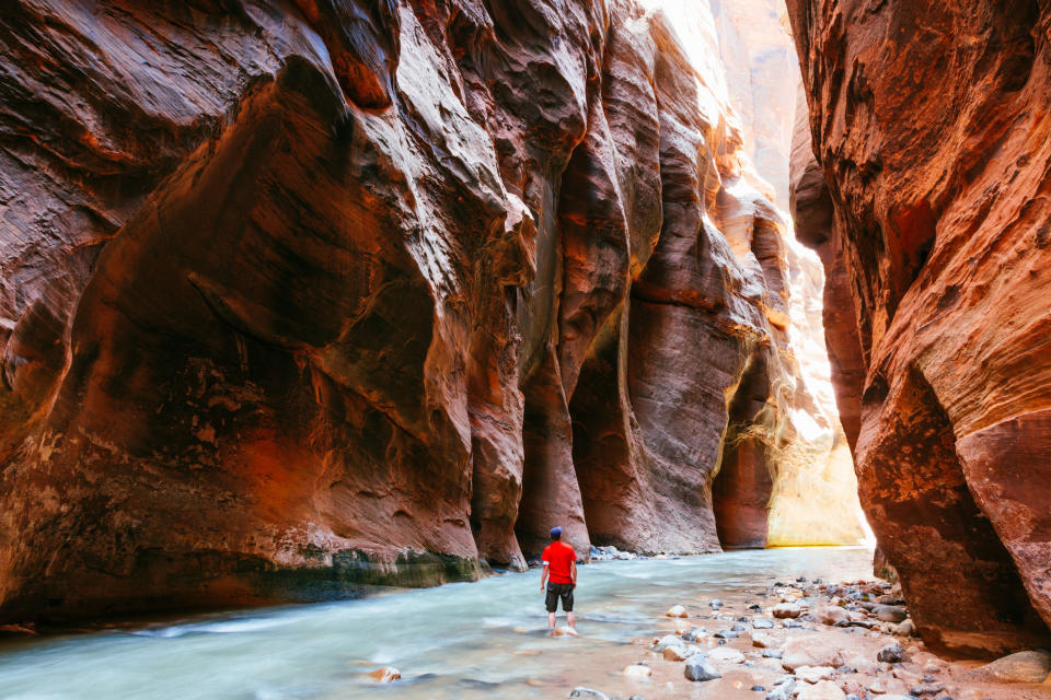 A man standing in a slot canyon