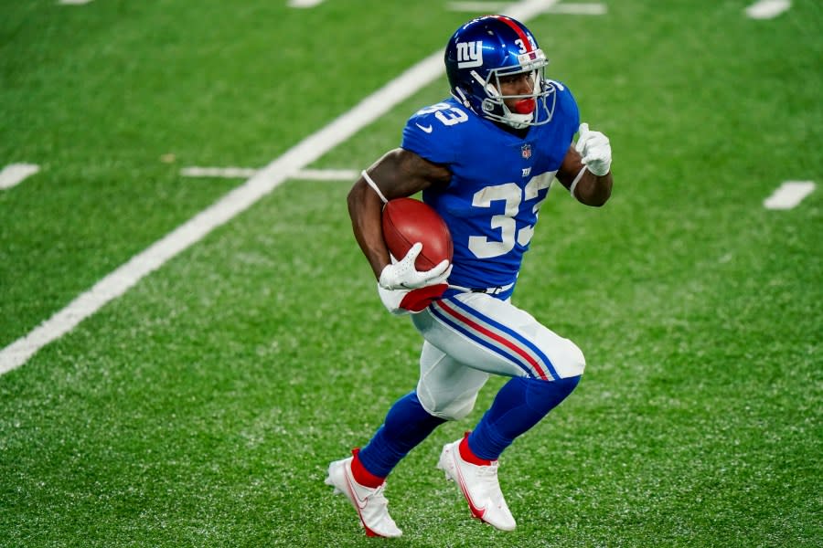 New York Giants running back Dion Lewis (33) gains yards in the first half of an NFL football game against the Cleveland Browns Sunday, Dec. 20, 2020, in East Rutherford, N.J. (AP Photo/Corey Sipkin)