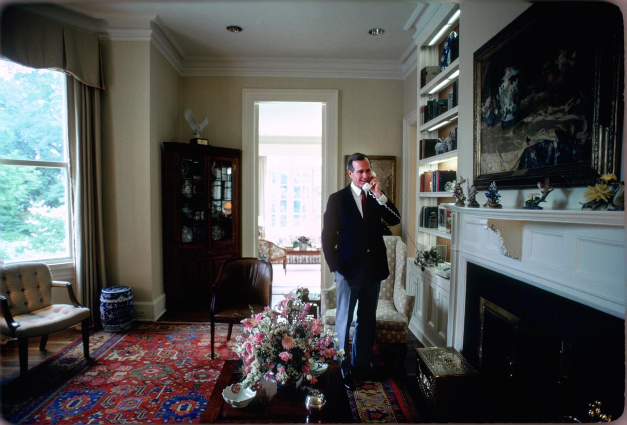 Vice President George H.W. Bush answers a phone call in the residence circa 1983.