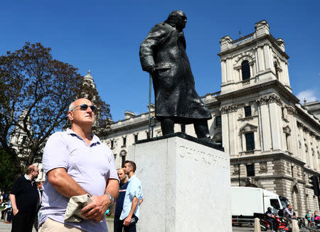 A member of the public observes a minute's silence following the recent Manchester Arena bombing, in Parliament Square in London, Britain, May 25, 2017. REUTERS/Neil Hall