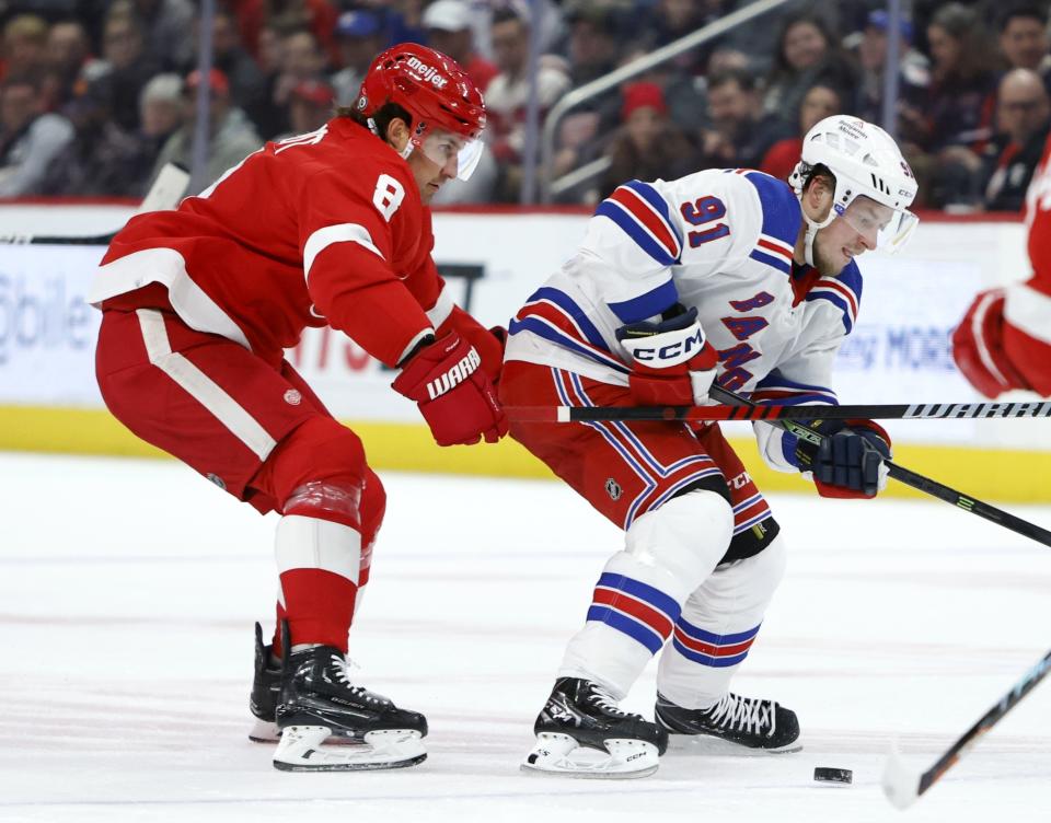 Detroit Red Wings defenseman Ben Chiarot (8) pushes New York Rangers right wing Vladimir Tarasenko (91) off the puck during the first period of an NHL hockey game Thursday, Feb. 23, 2023, in Detroit. (AP Photo/Duane Burleson)