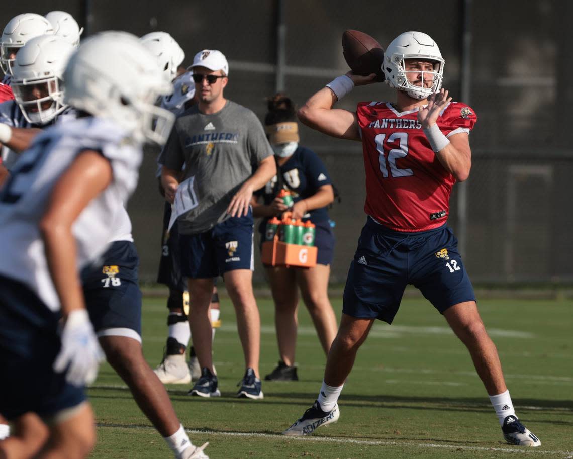 Quarterback Gunnar Holmberg, right, takes the snap and looks cross field during passing drills at practice. On Monday, August 1, 2022 FIU football team opened morning practiced to the media on the practice field on the Tamiami Campus.