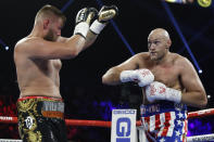 Tyson Fury, of England, right, and Tom Schwarz, of Germany, fight during a heavyweight boxing match Saturday, June 15, 2019, in Las Vegas. (AP Photo/John Locher)