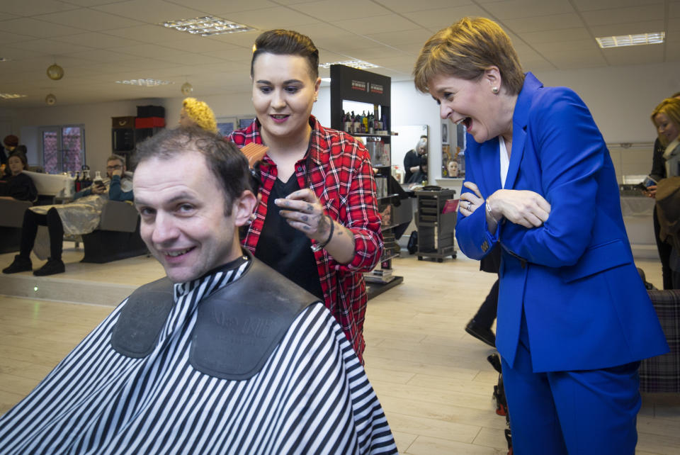 Hair we go: SNP leader Nicola Sturgeon gives her party's candidate for North East Fife Stephen Gethins a haircut, during a visit to Craig Boyd Hairdressing in Leven, Fife.