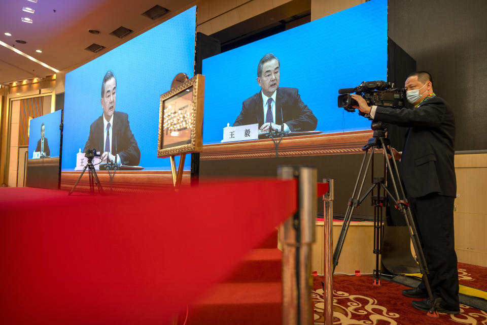 Chinese Foreign Minister Wang Yi speaks during a remote video press conference held on the sidelines of the annual meeting of China's National People's Congress (NPC) in Beijing, Sunday, March 7, 2021. (AP Photo/Mark Schiefelbein)