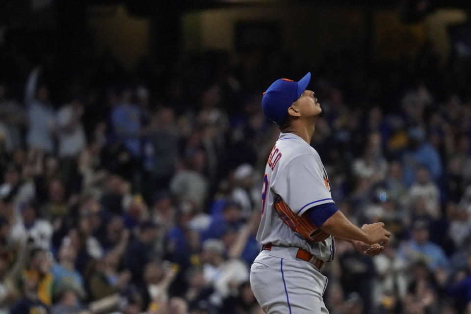 New York Mets' Carlos Carrasco reacts after giving up a two-run home run during the fourth inning of a baseball game against the Milwaukee Brewers Monday, April 3, 2023, in Milwaukee. (AP Photo/Aaron Gash)