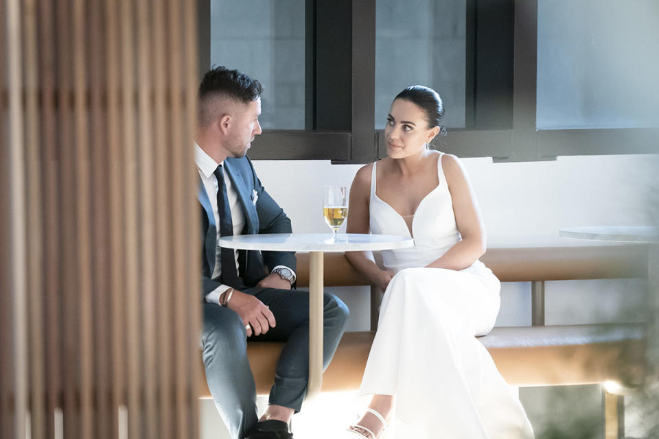 Harrison Boon and Bronte Schofield sit at a table to have a chat