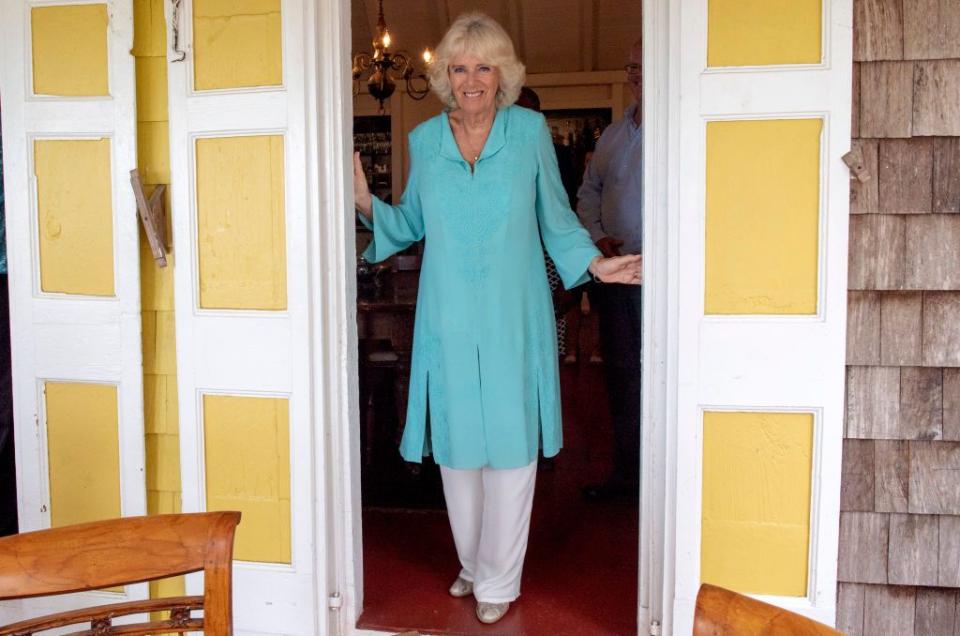 <p>While visiting St. Kitts and Nevis on a <a href="https://www.townandcountrymag.com/society/tradition/g26850147/prince-charles-camilla-parker-bowles-royal-tour-caribbean-2019-photos/" rel="nofollow noopener" target="_blank" data-ylk="slk:royal tour of the Caribbean;elm:context_link;itc:0;sec:content-canvas" class="link ">royal tour of the Caribbean</a>, Camilla wore a tiffany blue, embroidered caftan with white pants, turquoise drop earrings, and gold ballet flats. </p>