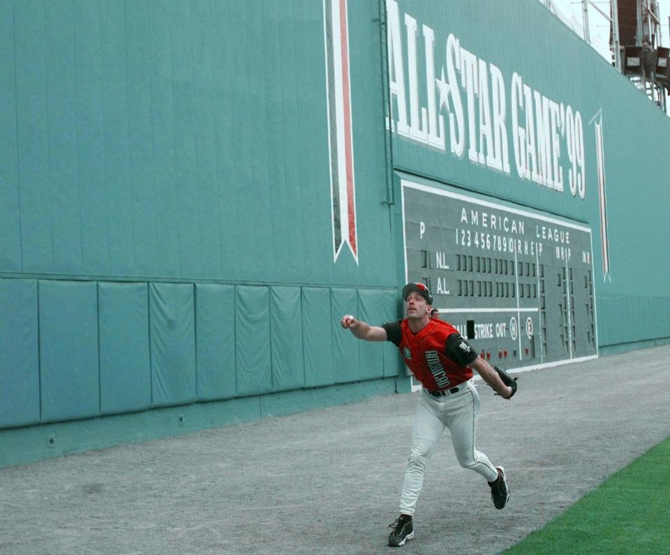 Baltimore Orioles' B.J. Surhoff chases down a ball off the Green Monster, Fenway Park's famed left field wall, during All-Star batting practice Monday, July 12, 1999 in Boston.