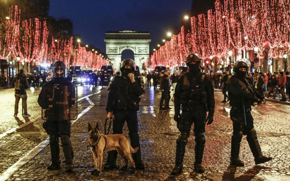 Police forces stand on the Champs Elysees  -  SAMEER AL-DOUMY/AFP