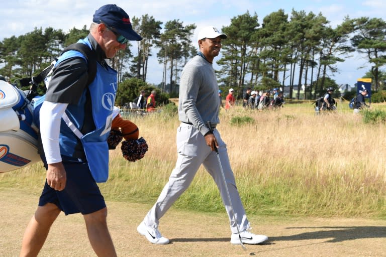 Tiger Woods with Jason Dufner's caddie during a practice round on Wednesday