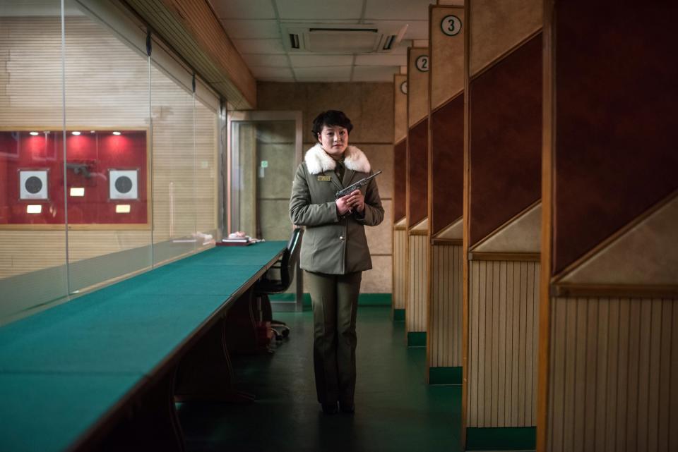 Shooting instructor Kim Su-Ryon poses for a portrait at the Meari Shooting Range in Pyongyang. Kim is holding a Paektusan target pistol, gifted by late North Korean leader Kim Il-Sung. Visitors to the range can pay $10 to shoot 10 rounds.