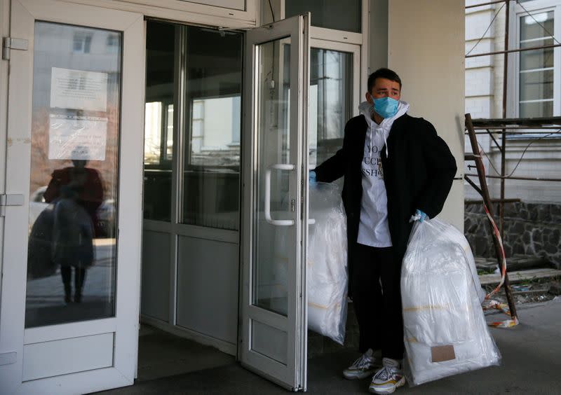 Ukrainian fashion designer Frolov holds a bag with medical protective outside a hospital in Kiev
