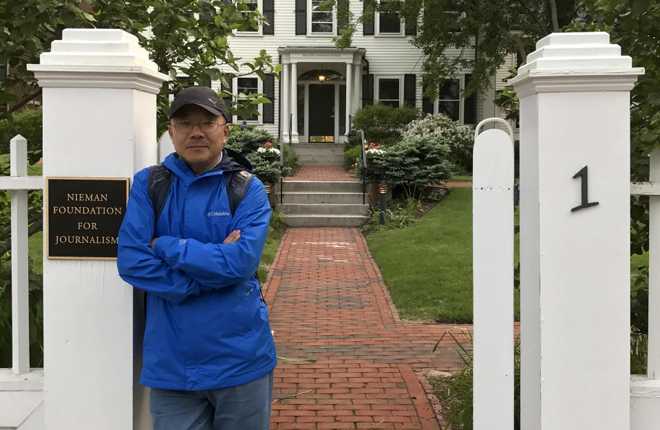 In this photo provided by the Dong family, Dong Yuyu stands at the gates of the Nieman Foundation for Journalism at Harvard University in Cambridge, Mass in May 2017. A veteran Chinese journalist who worked at a ruling Communist Party-affiliated newspaper and was a Harvard University fellow faces espionage charges after he was detained while meeting with a Japanese diplomat in a restaurant, his family said Monday. (Dong Family via AP)