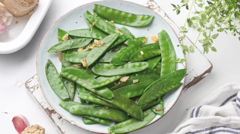 Snow peas on white plate