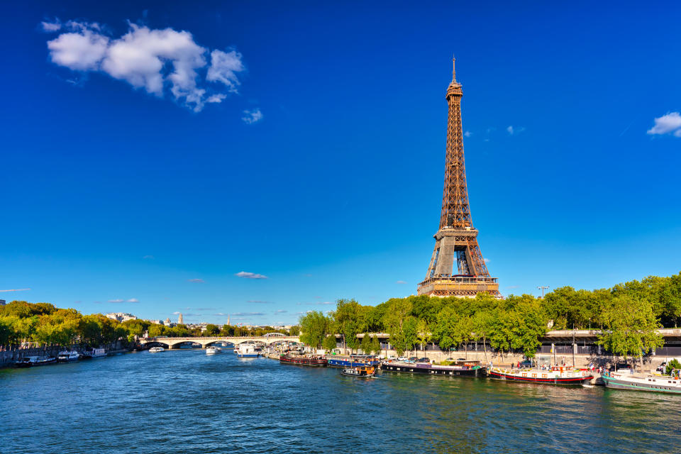 Eiffel Tower by the Seine River in Paris, France, during summer.