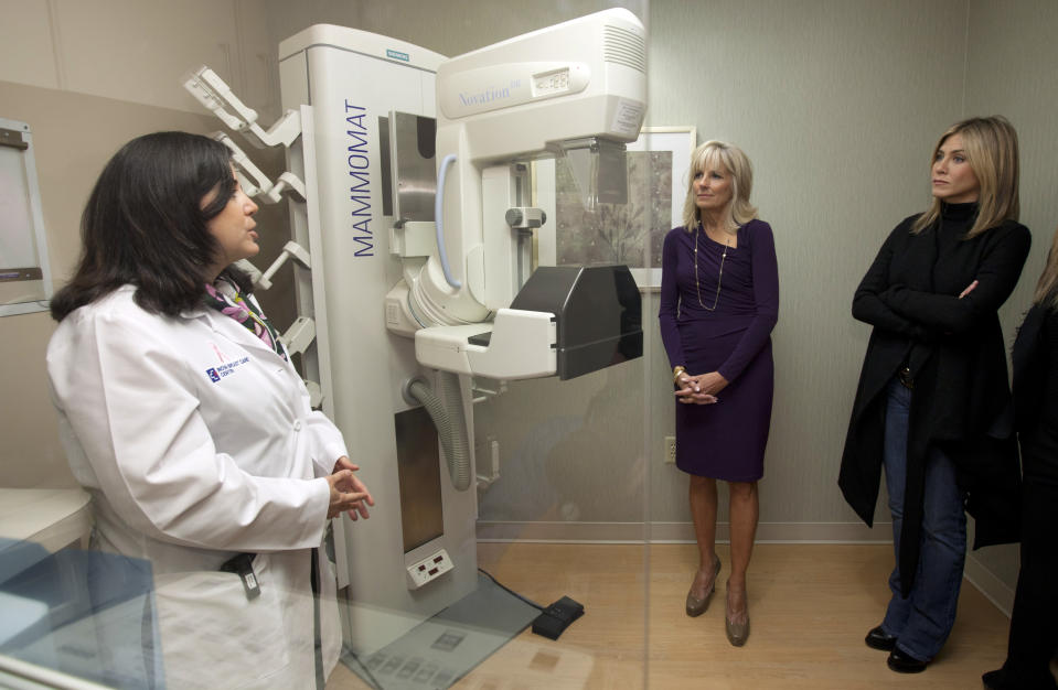 FILE - From left, Dr. Constanza Cocilovo, Jill Biden, and Jennifer Aniston participate in an event commemorating Breast Cancer Awareness Month at the Inova Alexandria Hospital at Mark Center, Oct. 3, 2011, in Alexandria, Va. (AP Photo/Carolyn Kaster, File)