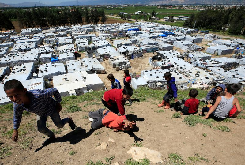 Syrian refugee children play together, as Lebanon extends a lockdown to combat the spread of the coronavirus disease (COVID-19) at a Syrian refugee camp in the Bekaa valley